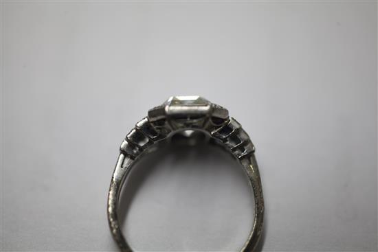 An Art Deco platinum single stone diamond and sapphire octagonal dress ring, size M.